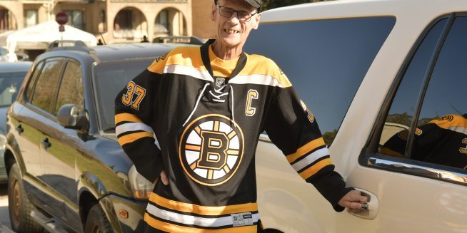 Richard in Bruins uniform is posing before he ride on a car.